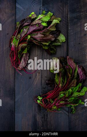 Fresh beetroot leaves on a wooden table Stock Photo