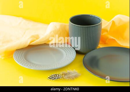 Set of crockery i trendy colors of the year 2021 - Ultimate grey and illuminating yellow. Kitchen utensils. Stock Photo