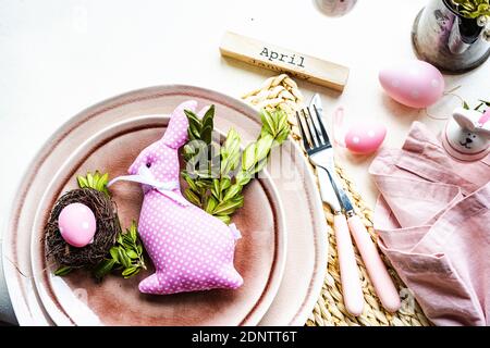 Easter place setting with an Easter bunny decoration on a table Stock Photo