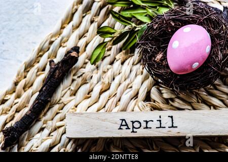Pink Easter egg in a bird's nest on a place mat Stock Photo