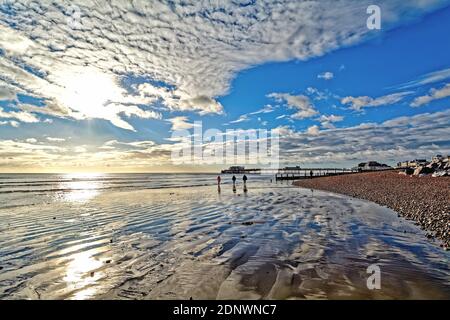 The pier at Worthing against a dramatic winter sunset and clouds west Sussex England UK Stock Photo