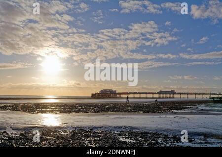 The pier at Worthing against a dramatic winter sunset and clouds west Sussex England UK Stock Photo