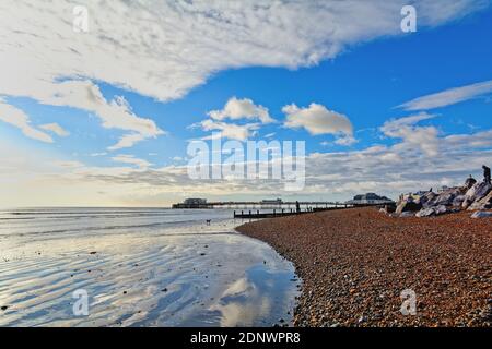 The pier at Worthing against a dramatic winter sunset and clouds west Sussex England UK Stock Photo