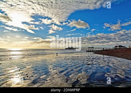 The pier at Worthing against a dramatic winter sunset and clouds west Sussex England UK Stock Photo