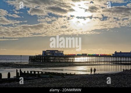 The pier at Worthing against a dramatic winter sunset and clouds west Sussex England UK Stock Photo