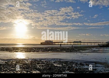 The pier at Worthing against a dramatic winter sunset and clouds west Sussex England UK Stock Photo