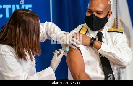 Vice Admiral (VADM) Jerome M. Adams, M.D., M.P.H., United States Surgeon General, receives a COVID-19 vaccine to promote the safety and efficacy of the vaccine at the White House in Washington, DC, Friday, December 18, 2020. Credit: Doug Mills/Pool via CNP /MediaPunch Stock Photo