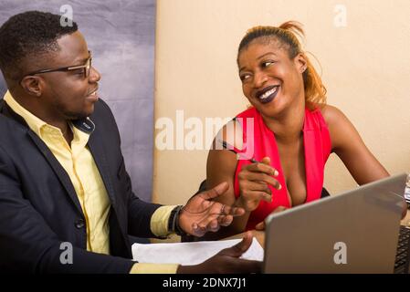 Teamwork: businessman and businesswoman working in office, they discuss and work on laptop. Stock Photo