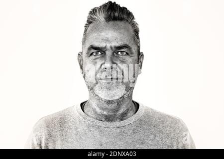 Middle aged man with modern hairstyle  looking at the camera with a serious expression in black and white Stock Photo