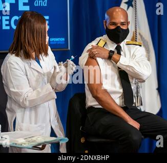 Washington, United States Of America. 18th Dec, 2020. Vice Admiral (VADM) Jerome M. Adams, M.D., M.P.H., United States Surgeon General, receives a COVID-19 vaccine to promote the safety and efficacy of the vaccine at the White House in Washington, DC, Friday, December 18, 2020. Credit: Doug Mills/Pool via CNP | usage worldwide Credit: dpa/Alamy Live News Stock Photo