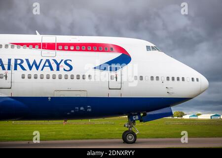 Storm clouds gather over the final resting place of the iconic British Airways Boeing 747 'Jumbo Jet' fleet as they wait on the tarmac to be scrapped Stock Photo