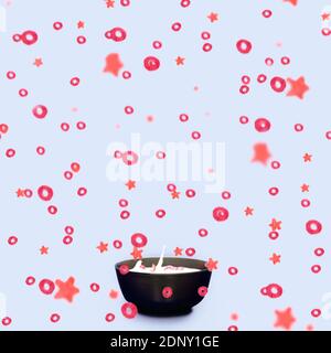 a bowl full of milk and falling cereal loops and stars shape all around - morning breakfast concept Stock Photo