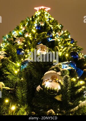 bottom view of decorated Christmas tree close up outdoors at night Stock Photo
