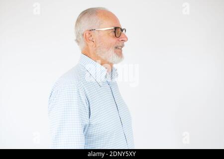 Closeup profile view of senior bearded man over white background. Stock Photo