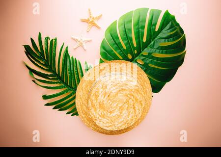 Straw beach hat and sun glasses top view on pink background, summer flat lay Stock Photo