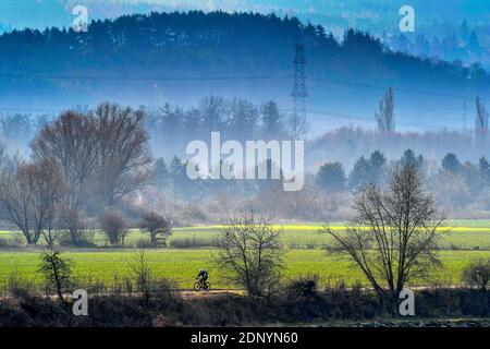 autumnal countryside with biker in distance Stock Photo