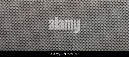 Dark metal surface with dots macro close up view. Pattern of grill on iron texture Stock Photo