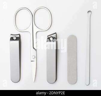 Set of metal personal trim tools isolated on white studio background. Steel scissors and clipper Stock Photo