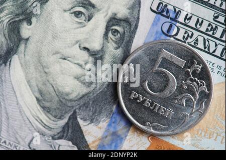 American and Russian currency theme. Metal coin on 100 dollar bill background Stock Photo