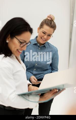 Smiling woman looking at documents Stock Photo