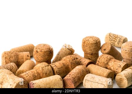 Used wine corks scattered randomly fill half frames on white background, space for text, Stock Photo