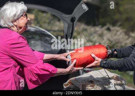 Senior woman loading car Stock Photo