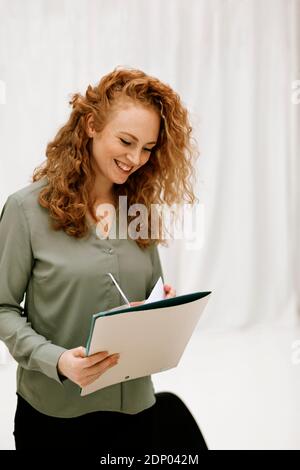 Smiling woman checking documents Stock Photo