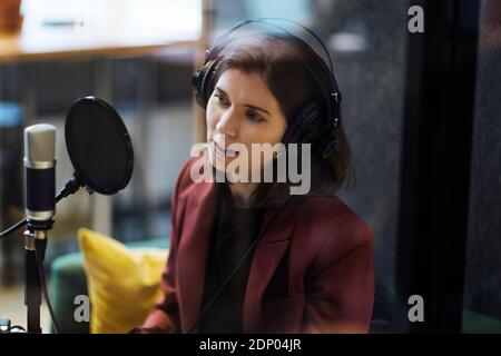 Woman broadcasting from radio station Stock Photo