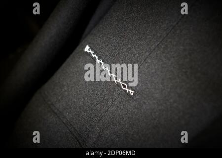 Dark grey suit fabric with sticked pocket. Close up. Stock Photo