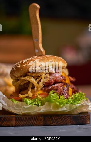 delicious burger with double cutlet on a wooden board Stock Photo