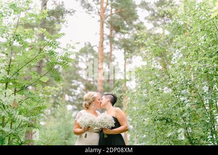 Brides in wedding dresses kissing Stock Photo