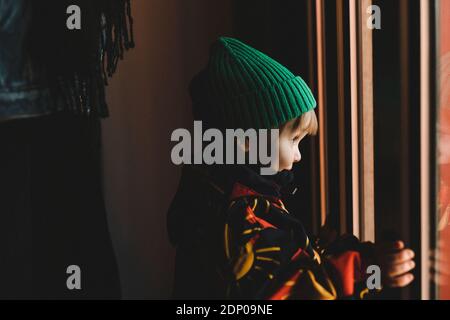 Girl looking through window Stock Photo