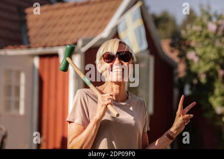 Happy woman holding croquet mallet Stock Photo