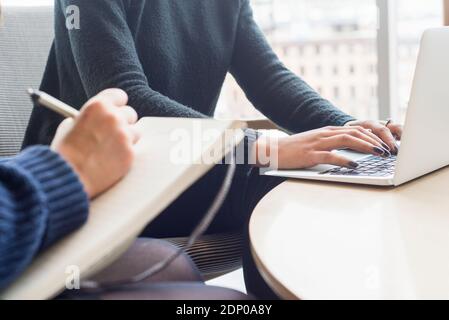 Hands on woman typing on laptop keyboard Stock Photo