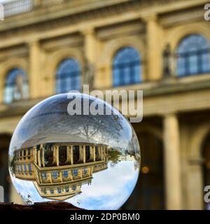 Crystal ball in which an upside down image of a historical building is visible. Stock Photo