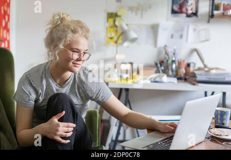Young woman using laptop at home Stock Photo