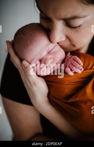 Mother hugging newborn baby Stock Photo