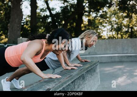 Couple doing push-ups together Stock Photo