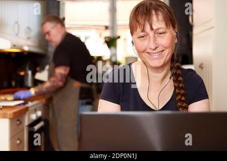 Smiling woman using laptop Stock Photo