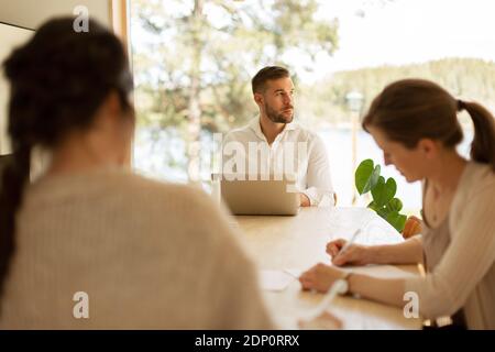 Man at table looking away Stock Photo