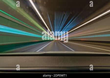 Speed driving car with light trails in a tunnel, fast accelerated highspeed photo. Stock Photo