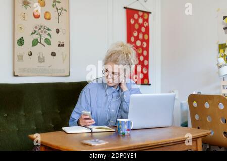 Young woman using laptop at home Stock Photo