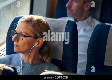 Woman looking through train window Stock Photo