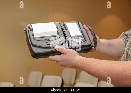 Man Holding Portable Barcode Printer and Scanner Set Device Stock Photo