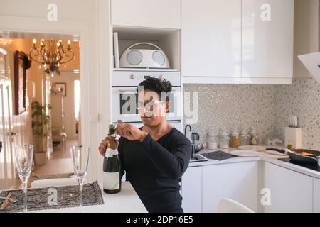 Man opening champagne bottle Stock Photo