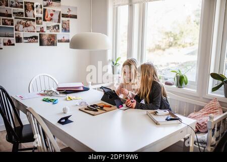Sisters using digital tablet Stock Photo