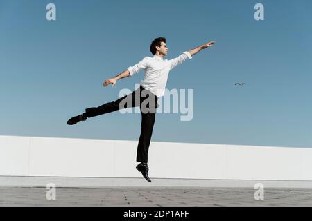 Artist practising on roof terrace Stock Photo