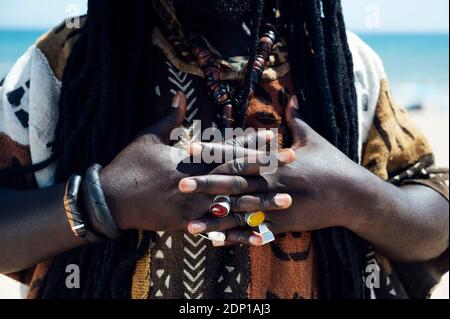 Hands with jeweled rings of man with dreadlocks Stock Photo