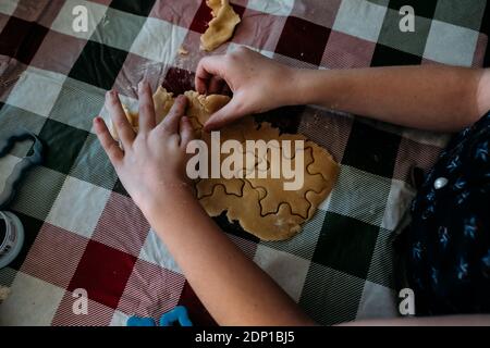 Overhead of young girl using cookie cutters Stock Photo