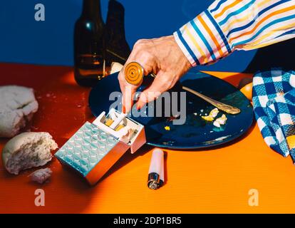 Hand of senior woman reaching for cigarette from cigarette pack Stock Photo